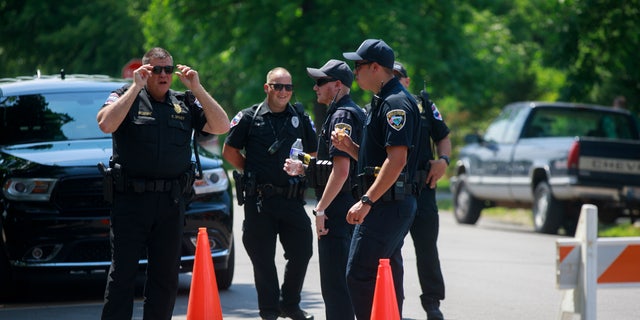 Indiana Police officers gather at a crime scene. (Photo by Jeremy Hogan/SOPA Images/LightRocket via Getty Images)