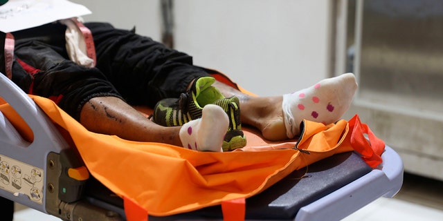 The body of a victim of a soccer match stampede lies on a gurney at the Saiful Anwar Hospital in Malang, East Java, Indonesia, Sunday, Oct. 2, 2022.