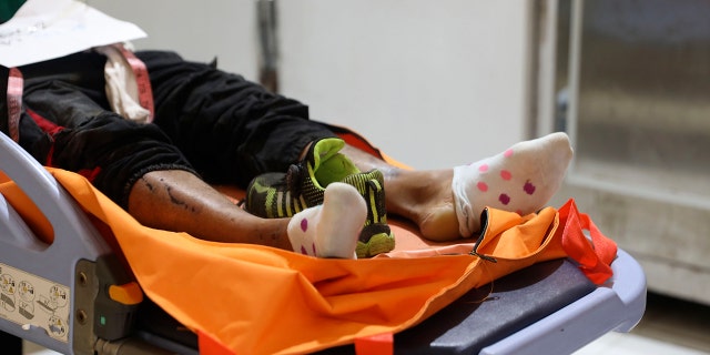 The body of a victim of a soccer match stampede lies on a gurney at the Saiful Anwar Hospital in Malang, East Java, Indonesia, Sunday, Oct. 2, 2022.