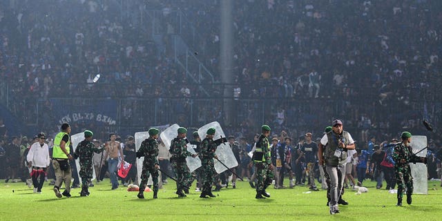 Indonesian military officials work to secure Kanjuruhan stadium in Malang, East Java, on Oct. 1, 2022, after a massive riot erupted between fans, killing at least 127 people.