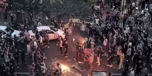 Iranians protest a 22-year-old woman Mahsa Amini's death after she was detained by the morality police, in Tehran in September.
