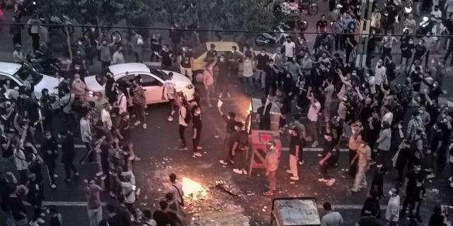 Iranians protest a 22-year-old woman Mahsa Amini's death after she was detained by the morality police, in Tehran in September.