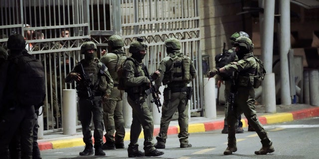 Israeli security forces patrol next to the scene of a shooting attack near the Shuafat refugee camp in Jerusalem, Saturday, Oct. 8, 2022. Israeli police say armed assailants have opened fire at an Israeli military checkpoint in east Jerusalem, seriously wounding at least two people. (AP Photo/Mahmoud Illean)
