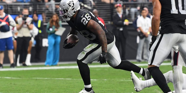Josh Jacobs #28 of the Las Vegas Raiders takes the ball for a touchdown in the fourth quarter against the Houston Texans at Allegiant Stadium on October 23, 2022 in Las Vegas, Nevada.