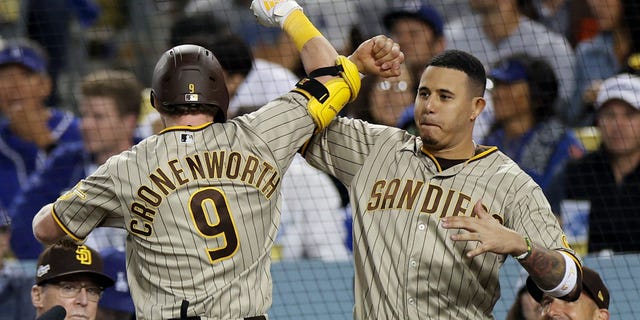 Jake Cronenworth #9 celebrates his home run with Manny Machado #13 of the San Diego Padres in the eighth inning in game two of the National League Division Series against the Los Angeles Dodgers at Dodger Stadium on October 12, 2022 in Los Angeles, California .