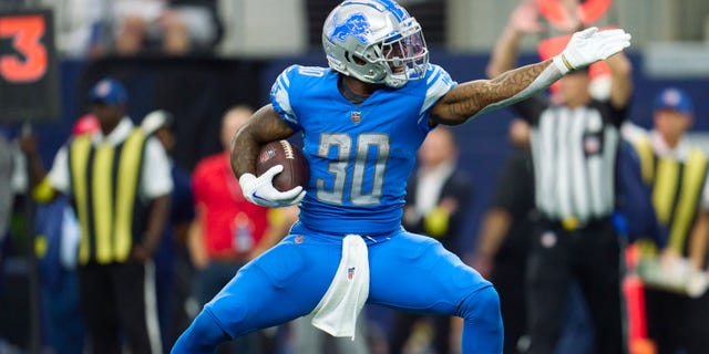 Detroit Lions' Jamaal Williams reacts after a play against the Dallas Cowboys during the first half of a game at AT and T Stadium on October 23, 2022 in Arlington, Texas.