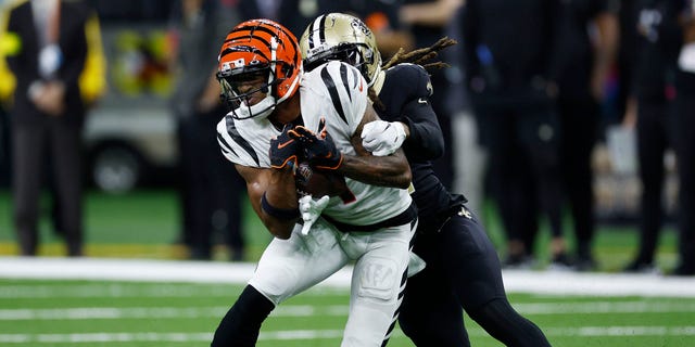 Ja'Marr Chase #1 of the Cincinnati Bengals is tackled by Bradley Roby #21 of the New Orleans Saints during the second half at Caesars Superdome on October 16, 2022 in New Orleans, Louisiana.
