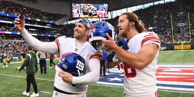 Graham Gano, left, and Jamie Gillan of the New York Giants celebrate after their win over the Green Bay Packers at Tottenham Hotspur Stadium Oct. 9, 2022, in London.