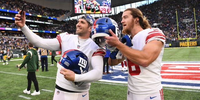 Graham Gano, left, and Jamie Gillan of the New York Giants celebrate after their win over the Green Bay Packers at Tottenham Hotspur Stadium Oct. 9, 2022, in London.