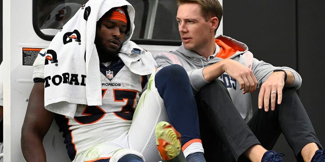 Denver Broncos running back Javonte Williams (33) is carted off the field during the second half of a game against the Las Vegas Raiders Oct. 2, 2022, in Las Vegas.