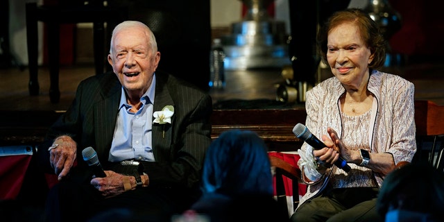 Former President Jimmy Carter and his wife former first lady Rosalynn Carter sit together during a reception to celebrate their 75th wedding anniversary July 10, 2021, in Plains, Georgia.