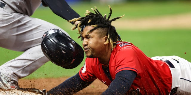 Jose Ramirez #11 of the Cleveland Guardians is tagged out at first base by Anthony Rizzo #48 of the New York Yankees during the third inning in game four of the American League Division Series at Progressive Field on Oct. 16, 2022 in Cleveland, Ohio.