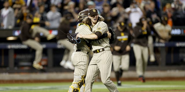 Josh Hader #71 of the San Diego Padres celebrates with Austin Nola #26 after defeating the New York Mets in game three to win the National League Wild Card Series at Citi Field on October 09, 2022 in the Flushing neighborhood of the Queens borough of New York City. the San Diego Padres defeated the New York Mets with a score of 6 to 0. 