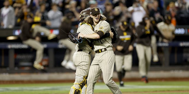 Josh Hader #71 of the San Diego Padres celebrates with Austin Nola #26 after defeating the New York Mets in game three to win the National League Wild Card Series at Citi Field on October 09, 2022 in the Flushing neighborhood of the Queens borough of New York City. the San Diego Padres defeated the New York Mets with a score of 6 to 0. 