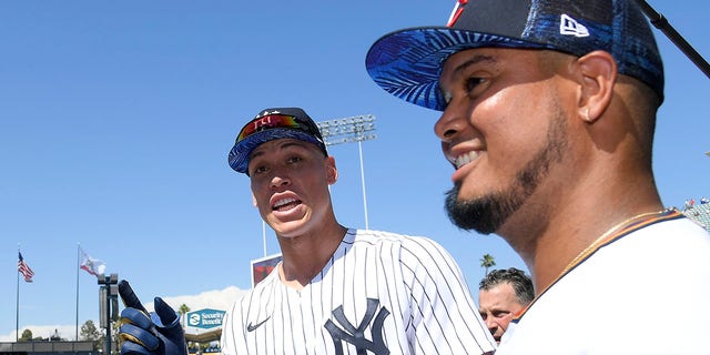 American League All-Stars Giancarlo Stanton, #27, (L) and Aaron Judge, #99 of the New York Yankees, (C) talk with Luis Arraez, #2 of the Minnesota Twins, (R) during the 2022 Gatorade All-Star Workout Day at Dodger Stadium on July 18, 2022 in Los Angeles.