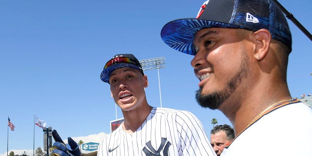 American League All-Stars Giancarlo Stanton, #27, (L) and Aaron Judge, #99 of the New York Yankees, (C) talk with Luis Arez, #2 of the Minnesota Twins, (R) 2022 Gatorade All-July 18 Star Workout Day at Dodger Stadium in Los Angeles, 2022.