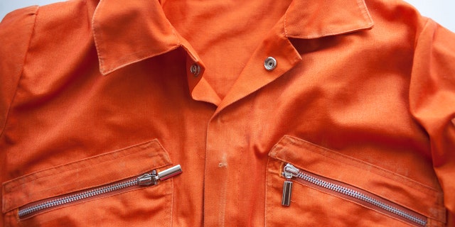 FILE - A close up photo of an orange prison jumpsuit.