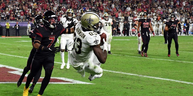 Juwan Johnson #83 of the New Orleans Saints catches a touchdown in the fourth quarter of a game against the Arizona Cardinals at State Farm Stadium in Glendale, Arizona on October 20, 2022.