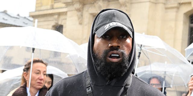 Kanye West attends the Givenchy Womenswear show as part of Paris Fashion Week in October 2022 amid antisemitism controversy.