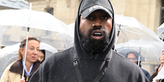 Kanye West attends the Givenchy Womenswear show as part of Paris Fashion Week in October 2022 amid antisemitism controversy.