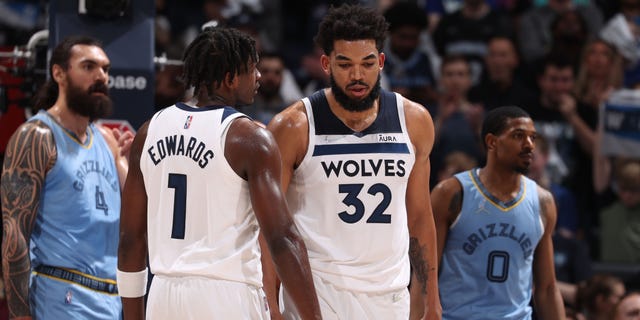 Anthony Edwards #1 and Karl-Anthony Towns #32 of the Minnesota Timberwolves speak during Game 4 of Round 1 of the 2022 NBA Playoffs on April 23, 2022 at Target Center in Minneapolis, Minnesota.