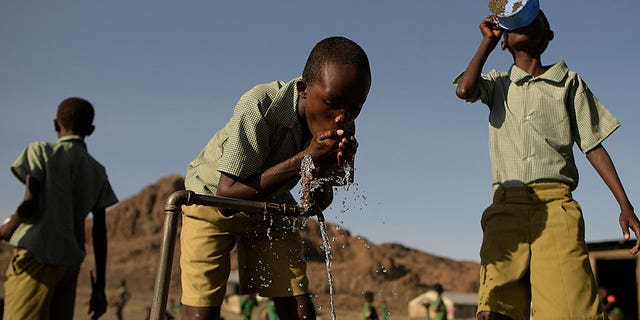 Millions of people across the Horn of Africa are facing severe hunger as the worst drought in 40 years devastates the region. Pictured: Kids drink from a tap in Loiyangalani, northern Kenya, on July 13, 2022. 