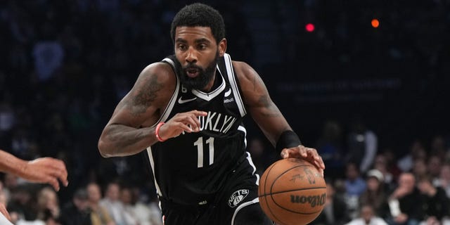 Kyrie Irving #11 of the Brooklyn Nets drives to the basket during the game against the New Orleans Pelicans on October 19, 2022, at Barclays Center in Brooklyn, New York.