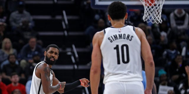 Kyrie Irving #11 of the Brooklyn Nets gestures towards Ben Simmons #10 during a game against the Memphis Grizzlies at FedExForum on October 24, 2022 in Memphis, Tennessee. 