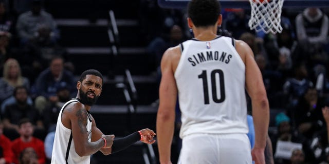 Kyrie Irving #11 of the Brooklyn Nets gestures towards Ben Simmons #10 during a game against the Memphis Grizzlies at FedExForum on October 24, 2022 in Memphis, Tennessee. 