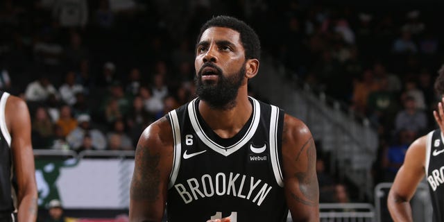 Kyrie Irving #11 of the Brooklyn Nets hits a free throw during a game against the Milwaukee Bucks at the Fiserv Forum Center in Milwaukee, Wisconsin, on October 12, 2022. 