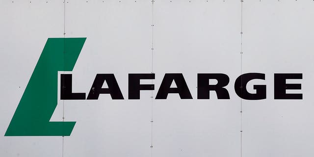 A logo of Lafarge, the world's largest cement maker, is pictured outside of a facility, in Paris,  Sept. 8, 2017.  Lafarge has pleaded guilty to paying $17 million to the Islamic State group so that a plant in Syria could remain open, in a case the Justice Department describes as the first of its kind. The charges were announced Tuesday in federal court in New York City. The allegations involve conduct that was earlier investigated by authorities in France.  