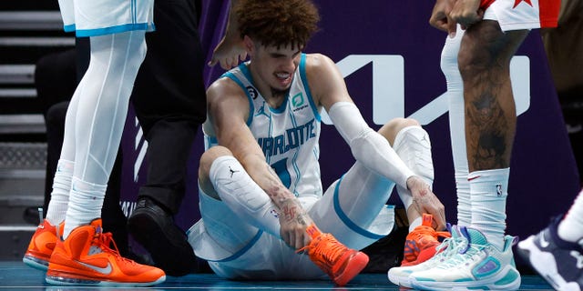 LaMelo Ball #1 of the Charlotte Hornets reacts after he is fouled and injured during the third quarter of the game against the Washington Wizards at Spectrum Center on Oct. 10, 2022 in Charlotte, North Carolina. 