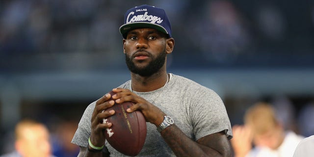 Lebron James of the Miami Heat throws a football at AT and T Stadium before a game between the New York Giants and the Dallas Cowboys Sept. 8, 2013, in Arlington, Texas.  