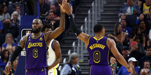 LeBron James of the Los Angeles Lakers high-fives Russell Westbrook during the first half of their game against the Golden State Warriors at Chase Center in San Francisco, California, on Tuesday.