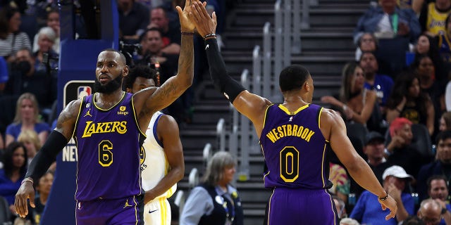 LeBron James #6 of the Los Angeles Lakers high-fives Russell Westbrook #0 during the 1st half of the game against the Golden State Warriors at Chase Center on Oct. 18, 2022 in San Francisco, California.