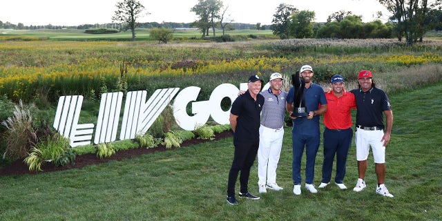 Team Captain Dustin Johnson of 4 Aces GC and teammates Pat Perez, Patrick Reed, and Talor Gooch pose with Greg Norman, CEO and commissioner of LIV Golf, after winning the team title during Day Three of the LIV Golf Invitational - Chicago at Rich Harvest Farms on Sept. 18, 2022 in Sugar Grove, Illinois.