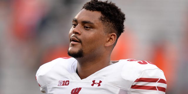 Wisconsin Badgers offensive lineman Logan Brown (50) walks off the field at the conclusion of the Big Ten conference college football game between the Wisconsin Badgers and the Illinois Fighting Illini on October 9, 2021, at Memorial Stadium in Champaign, Illinois.