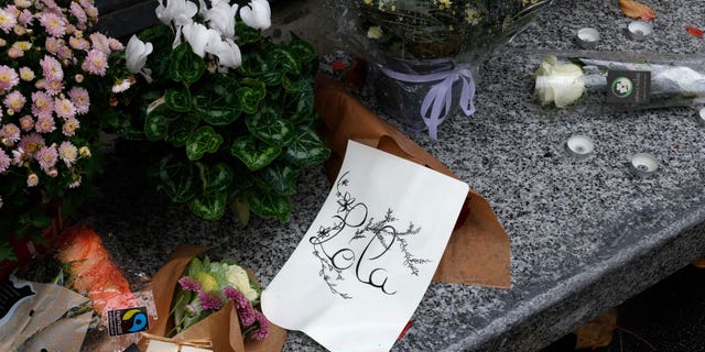 A photograph taken on Oct. 17, 2022, shows flowers displayed outside the Georges Brassens school in Paris, where a 12-year-old schoolgirl named Lola attended classes. Lola's body was discovered in a suitcase on Friday, Oct. 14, 2022.