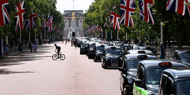 Taxi drivers join a demonstration along the Mall in central London on June 11, 2014.