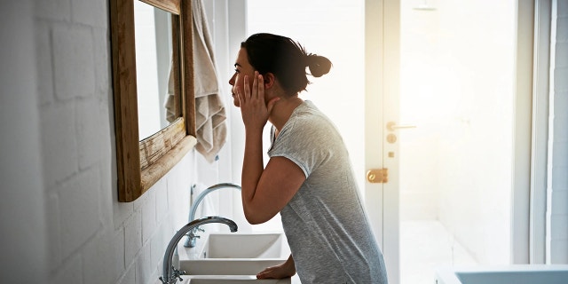 A woman examines her face in the mirror. "The truth is," said Dr. Frey, "science hasn’t found a single ingredient to reverse the aging process. It is inevitable, and it is irreversible."