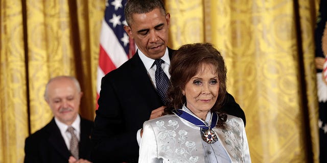 Former President Barack Obama awarded the Presidential Medal of Freedom to Loretta Lynn in the East Room at the White House on Nov. 20, 2013, in Washington, D.C. Lynn started out in Butcher Holler, Tennessee, sharing a one-room cabin with her parents and seven siblings.