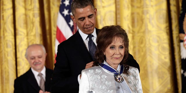 Former President Barack Obama awarded the Presidential Medal of Freedom to Loretta Lynn in the East Room at the White House on Nov. 20, 2013, in Washington, D.C. Lynn started out in Butcher Holler, Tennessee, sharing a one-room cabin with her parents and seven siblings.
