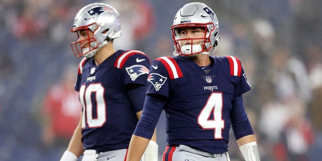 Mac Jones, left, and Bailey Zappe of the New England Patriots before the game against the Chicago Bears at Gillette Stadium on October 24, 2022 in Foxborough.