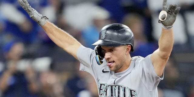 Mitch Haniger of the Seattle Mariners celebrates after scoring against the Toronto Blue Jays during Game 2 of the American League Wild Card Series at the Rogers Center in Toronto on October 8, 2022.