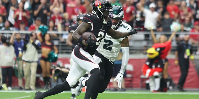 Wide receiver Marquise Brown (2) of the Arizona Cardinals runs for a touchdown ahead of cornerback Darius Slay (2) of the Philadelphia Eagles during a game at State Farm Stadium Oct. 9, 2022, in Glendale, Ariz. 