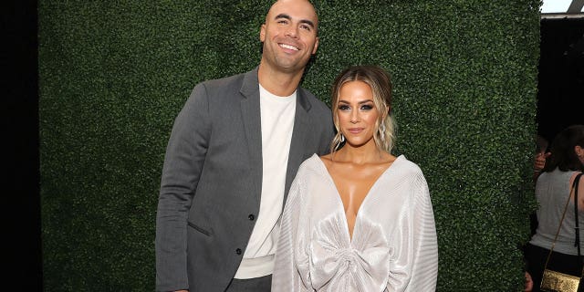 Mike Caussin and Jana Kramer arrive to the 2019 E! People's Choice Awards held at the Barker Hangar on November 10, 2019.