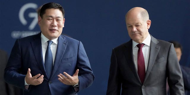 German Chancellor Olaf Scholz (right) and Mongolian Prime Minister Luvsannamsrain Oyun-Erdene (left) speak on their way to a joint press conference in Berlin, Germany, on Oct. 14, 2022.