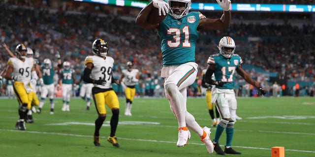 Raheem Mostert #31 of the Miami Dolphins scores a touchdown during the first quarter against the Pittsburgh Steelers at Hard Rock Stadium on October 23, 2022, in Miami Gardens, Florida. 