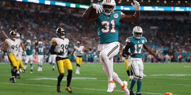 Raheem Mostert #31 of the Miami Dolphins scores a touchdown during the first quarter against the Pittsburgh Steelers at Hard Rock Stadium on October 23, 2022, in Miami Gardens, Florida.