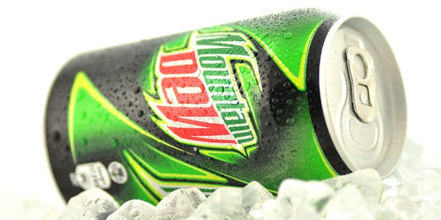 Kwidzyn, Poland - March 15, 2014: Can of Mountain Dew drink isolated on white. Mountain Dew citrus-flavored soft drink produced by PepsiCo. Mountain Dew was introduced in 1940